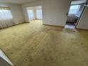 Bright living room with large windows, and a view of the kitchen at 9950 62Nd N Ter # 401, St Petersburg, FL 33708