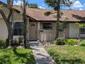 Charming townhome featuring a walkway leading to the front door and complemented by manicured landscaping at 5231 Brassy Loop, North Port, FL 34287