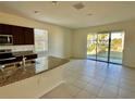 Open floor plan featuring sliding glass doors for natural light and tile flooring at 8697 Milestone Dr, Sarasota, FL 34238