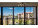A beautiful view of a green lawn with a multi-story building in the background, seen through windows at 3006 Caring Way # 325, Port Charlotte, FL 33952