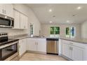 Modern kitchen features stainless steel appliances, granite countertops, and ample cabinet space at 3482 Dunkirk St, Port Charlotte, FL 33980