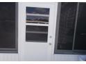 White exterior door with window panes at 6337 Fantasy Ct, North Port, FL 34287