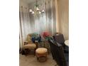 Sunroom features a rocking chair, side table, and window curtains at 6337 Fantasy Ct, North Port, FL 34287