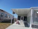 Mobile home with covered patio and seating area at 6337 Fantasy Ct, North Port, FL 34287