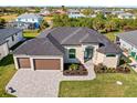 Aerial view of home showcasing roof, landscaping and driveway at 9437 Galaxie Cir, Port Charlotte, FL 33981