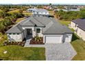 Aerial view of house showing the property, landscaping, and driveway at 9445 Galaxie Cir, Port Charlotte, FL 33981