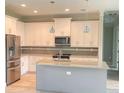 Modern kitchen with island and stainless steel appliances at 2563 Longworthy Rd, North Port, FL 34288