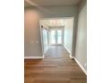 Inviting foyer with light hardwood floors and modern light fixture, complemented by natural light at 13654 Allamanda Cir, Port Charlotte, FL 33981