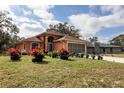 House exterior showcasing a peach-colored home with lush landscaping at 11907 De Leon Dr, North Port, FL 34287