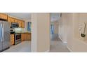 Kitchen with stainless steel appliances and light wood cabinets at 11907 De Leon Dr, North Port, FL 34287
