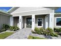 Front entrance with double doors, a walkway, and landscaping at 2033 Treasure Ln, Punta Gorda, FL 33982