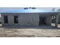 Unfinished home exterior with block walls and blue tarp at 2297 Longworthy Rd, North Port, FL 34288