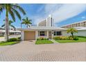 Quaint beachfront cottage with a paved driveway and landscaping at 6300 Midnight Pass Rd # 20, Sarasota, FL 34242