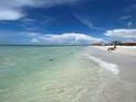 Peaceful beach scene with calm water and white sand at 6300 Midnight Pass Rd # 20, Sarasota, FL 34242