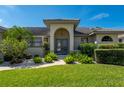 Inviting front entrance with double doors and manicured landscaping, providing great curb appeal at 2505 Rio Tiber Dr, Punta Gorda, FL 33950