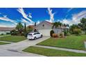 House with a two-car garage and manicured lawn, located on a quiet street at 234 Fields Se Ter, Port Charlotte, FL 33952