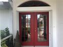 Red double front doors with a decorative glass panes at 431 San Felix St, Punta Gorda, FL 33983