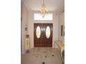 Bright and spacious entryway with double doors and tile flooring at 1307 Tidy Ln, Punta Gorda, FL 33983