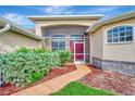 Inviting front entry with a screened porch and red door at 8430 Acorn Blvd, Punta Gorda, FL 33982
