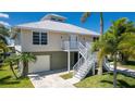 Two-story home with attached garage and exterior stairs at 24261 Captain Kidd Blvd, Punta Gorda, FL 33955