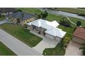 Single-Gathering home with metal roof, two car garage, and nicely landscaped yard at 2325 Padre Island Dr, Punta Gorda, FL 33950