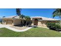 Single-Gathering home exterior showcasing tile roof and landscaped yard at 27200 San Marino Dr, Punta Gorda, FL 33983