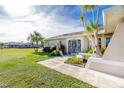 Side view of a house with a stone facade and a spacious lawn at 1759 Nuremberg Boulevard, Punta Gorda, FL 33983