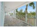 Condo hallway with tiled floors and balcony access at 5127 Melbourne St # F-204, Port Charlotte, FL 33980