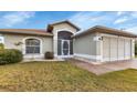 Single-story home with a covered entryway and landscaping at 176 Jennifer Dr, Rotonda West, FL 33947