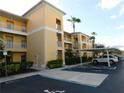 Condo building exterior with parking and landscaping at 2081 Willow Hammock Cir # F105, Punta Gorda, FL 33983