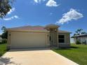 Charming single-story home with a two-car garage, well-manicured lawn, and inviting curb appeal at 22235 Albany Ave, Port Charlotte, FL 33952