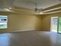 Large living room featuring tile flooring, a ceiling fan, and sliding glass doors to outside at 22235 Albany Ave, Port Charlotte, FL 33952