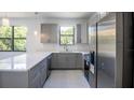 Modern kitchen with gray cabinets, stainless steel appliances, and quartz countertops at 3225 Amanda St, Punta Gorda, FL 33950