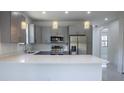 Modern kitchen with gray cabinets, stainless steel appliances, and quartz countertops at 3225 Amanda St, Punta Gorda, FL 33950