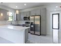 Modern kitchen with gray cabinets, stainless steel appliances, and quartz countertops at 3225 Amanda St, Punta Gorda, FL 33950