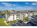 Condo building with parking and palm trees at 1439 Mediterranean Dr # C, Punta Gorda, FL 33950