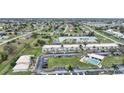 Aerial view of a condo community with a pool and ample parking at 26485 Rampart Blvd # D28, Punta Gorda, FL 33983