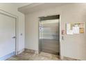 Condo elevator with stainless steel doors and a tile floor outside at 3322 Purple Martin Dr # 135, Punta Gorda, FL 33950
