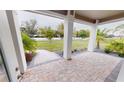 Covered porch with paver floor and view of backyard at 28968 Gin Ln, Punta Gorda, FL 33982
