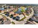Aerial view of a beautiful home in a golf course community with a lake at 1712 Lastingham Ln, Port Charlotte, FL 33980