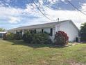 Side view of a white house with landscaping at 21277 Edgewater Dr, Port Charlotte, FL 33952
