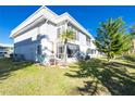 Back exterior with patio and grassy area at 22375 Edgewater Dr # 239, Port Charlotte, FL 33980