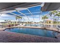 Relaxing pool area with covered lanai overlooking the canal at 3705 Toulouse Ct, Punta Gorda, FL 33950