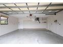 Spacious garage with overhead storage and extra space at 21445 Peachland Blvd, Port Charlotte, FL 33954