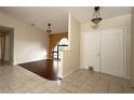 Bright and spacious entryway with tile flooring, double doors, and arched window at 21445 Peachland Blvd, Port Charlotte, FL 33954