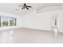 Bright living room with tile floors, vaulted ceilings and a ceiling fan at 18882 Ayrshire Cir, Port Charlotte, FL 33948