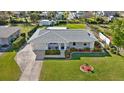 Single-story home with a spacious yard, driveway, and detached shed at 318 Timbruce Nw Ln, Port Charlotte, FL 33952