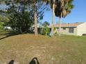 Large backyard with mature trees and privacy at 7211 Elyton Dr, North Port, FL 34287