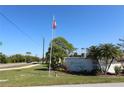 Fiddlers Green community entrance with signage and landscaping at 6800 Placida Rd # 144, Englewood, FL 34224