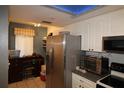 Kitchen with stainless steel appliances and an adjacent workspace at 6800 Placida Rd # 144, Englewood, FL 34224